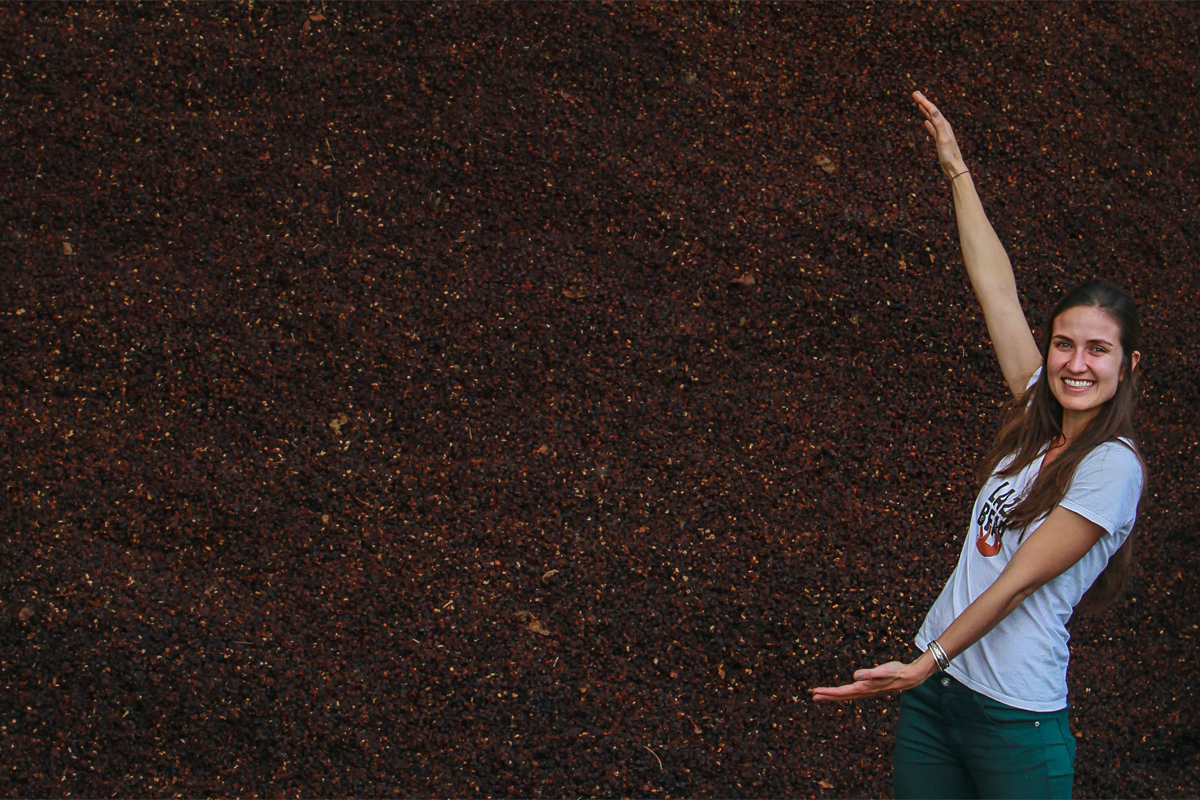Daniela Uribe with a mountain of cascara (photo courtesy of Lazy Bear Tea)