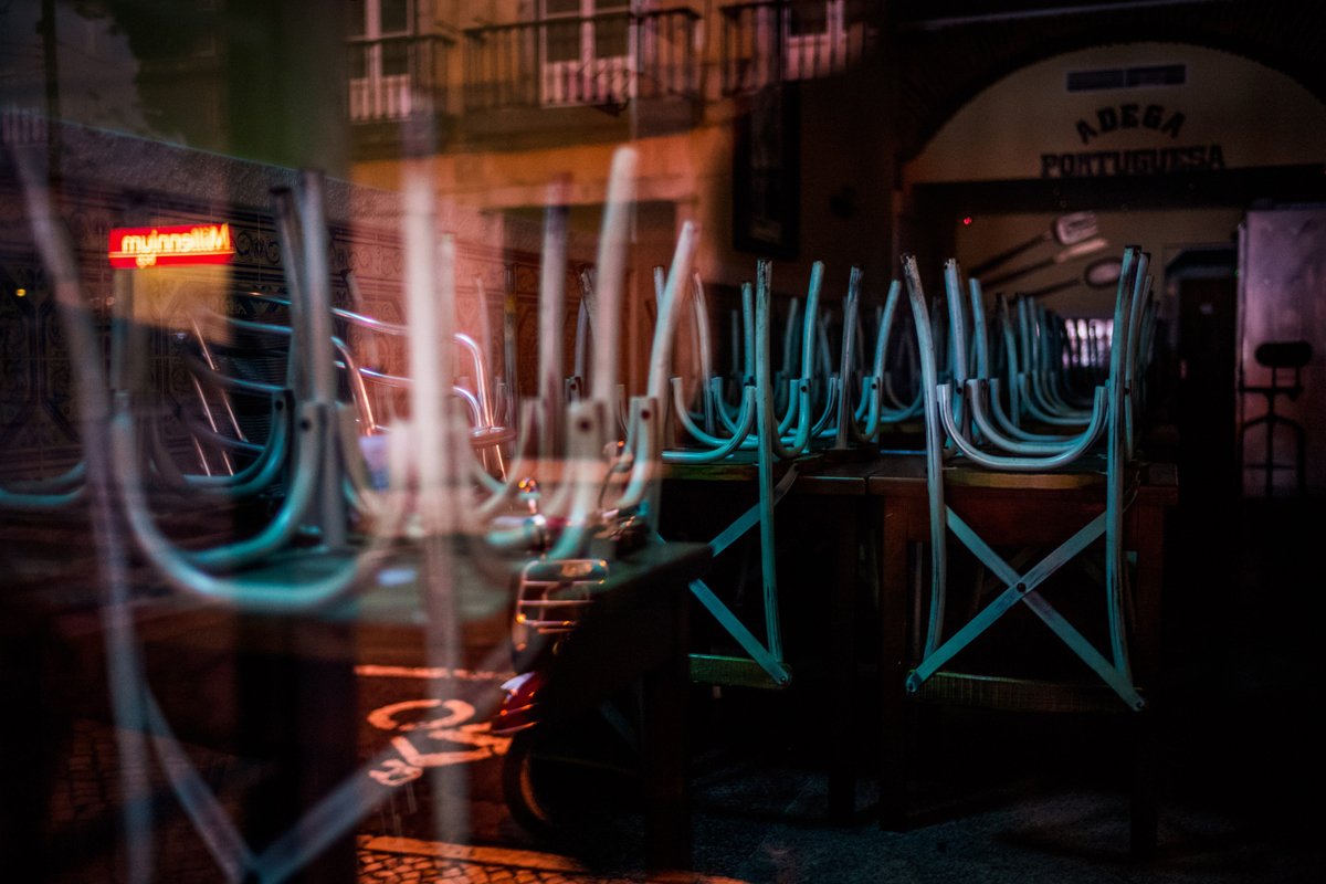 an empty restaurant with stacked chairs on tables after a #MeToo reckoning over its toxic work environment