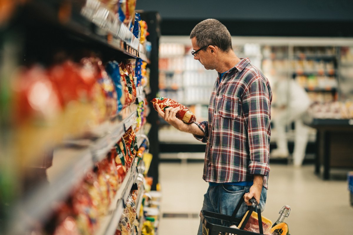 A person shopping for food using SNAP funds. It may not be possible for them to buy candy or soda. (Photo credit: Giselle Flissak, Getty Images)
