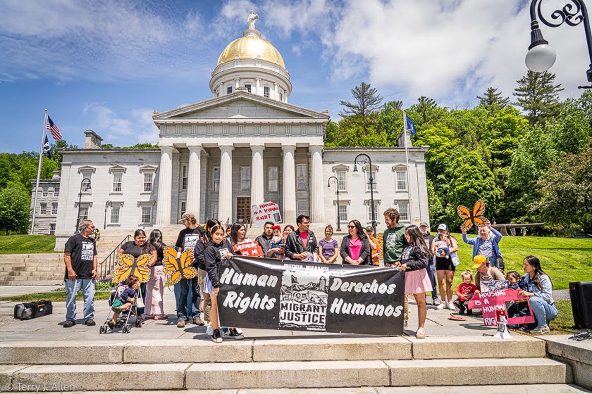 Immigrant community leaders and supporters gather in front of the Vermont State House on Friday, June 13th, to celebrate the passage of S. 127, a new state law protecting immigrant housing rights. The celebration was organized by Migrant Justice, a Vermont-based human rights organization founded and led by immigrant farmworkers. (Photo credit: Terry Allen)