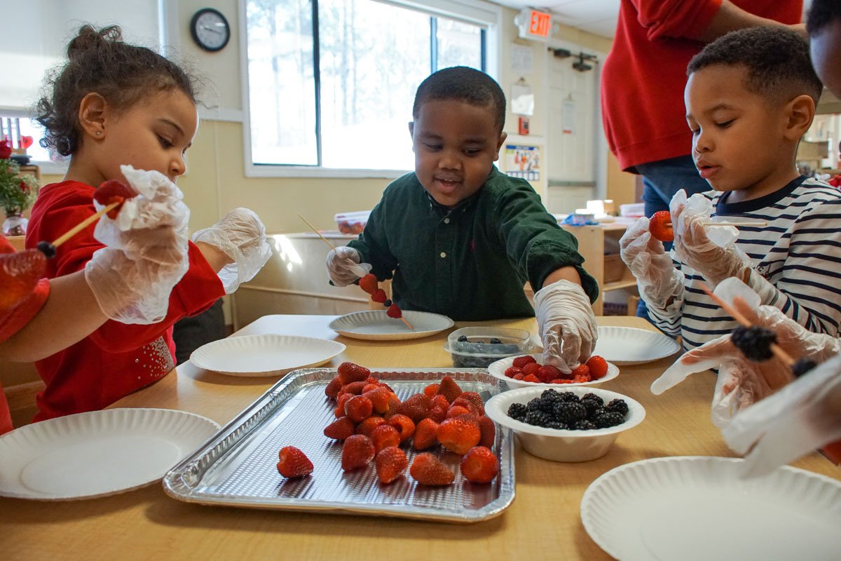 Children engaging in a hands-on learning activity with berries as part of a farm-to-ECE program. (Photo credit: Marcello Cappellazzi)