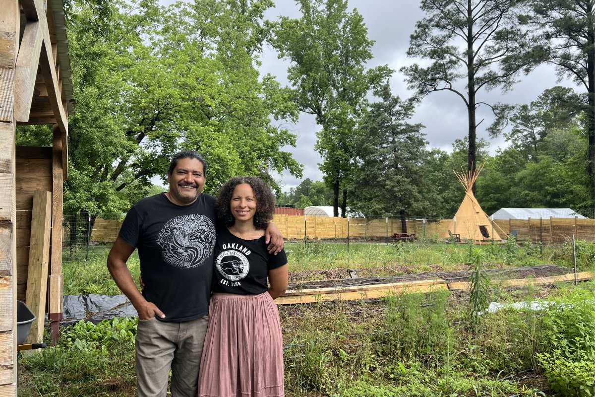 Hector Lopez and Phoebe Gooding at the center of their 1.3-acre urban permaculture farm, Hawk’s Nest Healing Gardens, in Durham, NC. (Photo credit: Nicole J. Caruth)