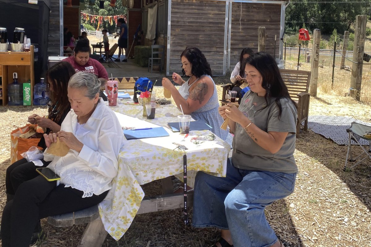 Women making medicine bags filled with herbs and stones on Native Women’s Wellness Day at Remagination Farm, June 2025. (Photo courtesy of Remagination Farm)