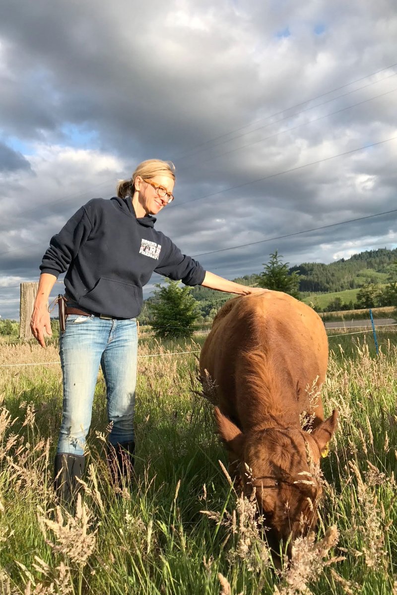 Brenda Smola-Foti, owner of Tabula Rasa Farms, with one of her cows. Agritourism